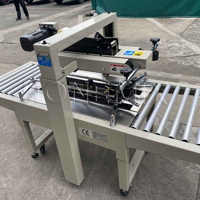 220V / 50HZ স্বয়ংক্রিয় প্যাকিং মেশিন 12mm কার্টন বক্স সিলার আঠালো টেপিং